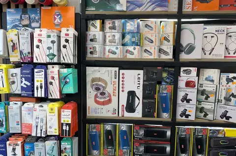 A workbench of phones and parts at a repair shop